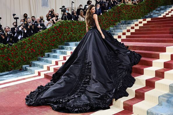 Kendall Jenner  wore a black dress featuring an epic train but decided to rock unique makeup featuring a no eyebrow look.