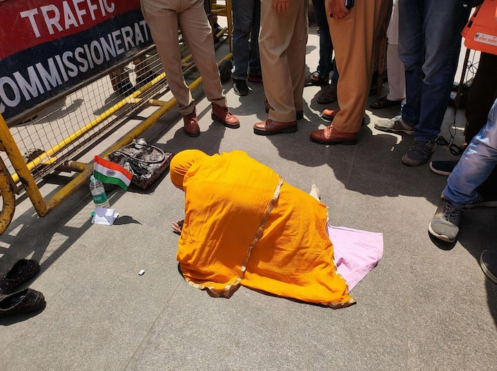 Police personnel keep vigil as a Muslim devotee offiers Friday namaz outside the Gyanvapi Masjid during a video-graphic survey of its premises in Varanasi. (Source: PTI)