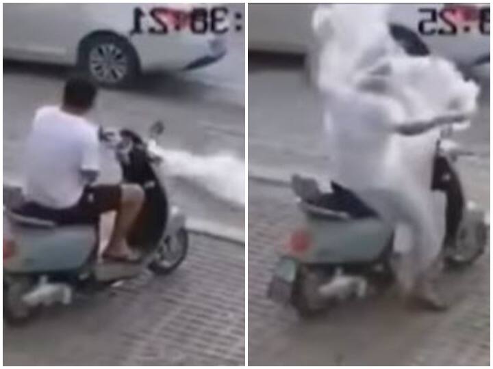 Person standing on side of road was wrapped in plastic flying in air Watch: सड़क किनारे खड़े शख्स पर लिपटी प्लास्टिक, डराने के साथ हंसा देगा वीडियो