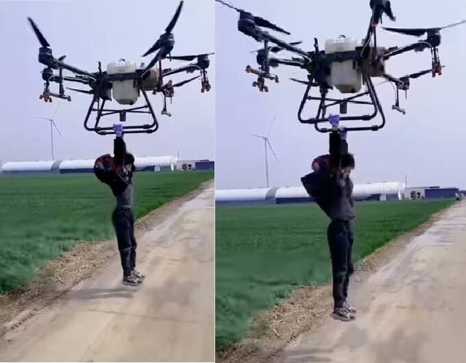 A video viral on internet with a man hanged with big drone Drone Video: ડ્રૉન પર લટકીને માણસ ઉડ્યો હવામાં, લોકો રહી ગયા જોતા..........