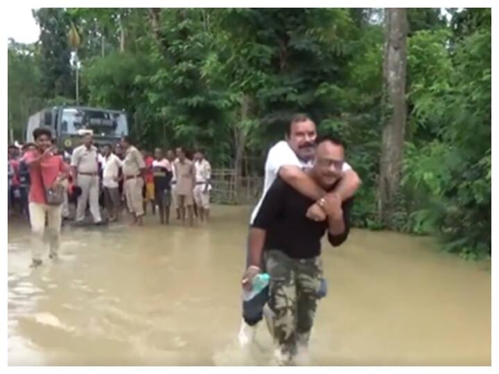 Assam: BJP MLA Draws Flak For Piggyback Ride During Flood Review | WATCH Assam: BJP MLA Draws Flak For Piggyback Ride During Flood Review | WATCH