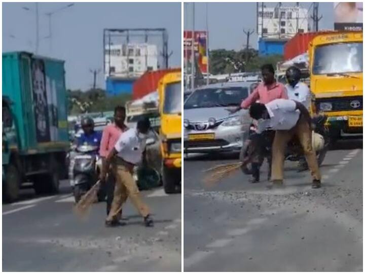 Watch: ट्रैफिक पुलिसकर्मी ने सड़क से कंकड़ और पत्थर हटाने के लिए लगाई झाड़ू, वीडियो ने जीता दिल traffic policeman sweeping pebbles off busy road goes viral Watch: ट्रैफिक पुलिसकर्मी ने सड़क से कंकड़ और पत्थर हटाने के लिए लगाई झाड़ू, वीडियो ने जीता दिल