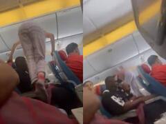 Watch: विमान में महिला ने अचानक खिड़की की सीट पर जाने के लिए यात्रियों के ऊपर चढ़कर लगाई छलांग, सोशल मीडिया पर शुरू हो गई बहस
