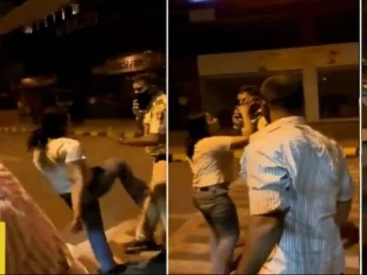 Watch: Drunk woman kicks and abuses police official Watch Video: குடிபோதையில் காவலரை தாக்கி அத்துமீறும் இளம்பெண்! - வைரலாகும் வீடியோ!