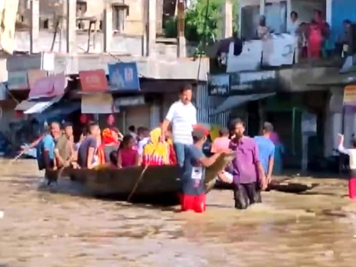 Assam Floods Latest Updates People Commute On Boats Due To Inundated Roads In Silchar Town Cachar District Video