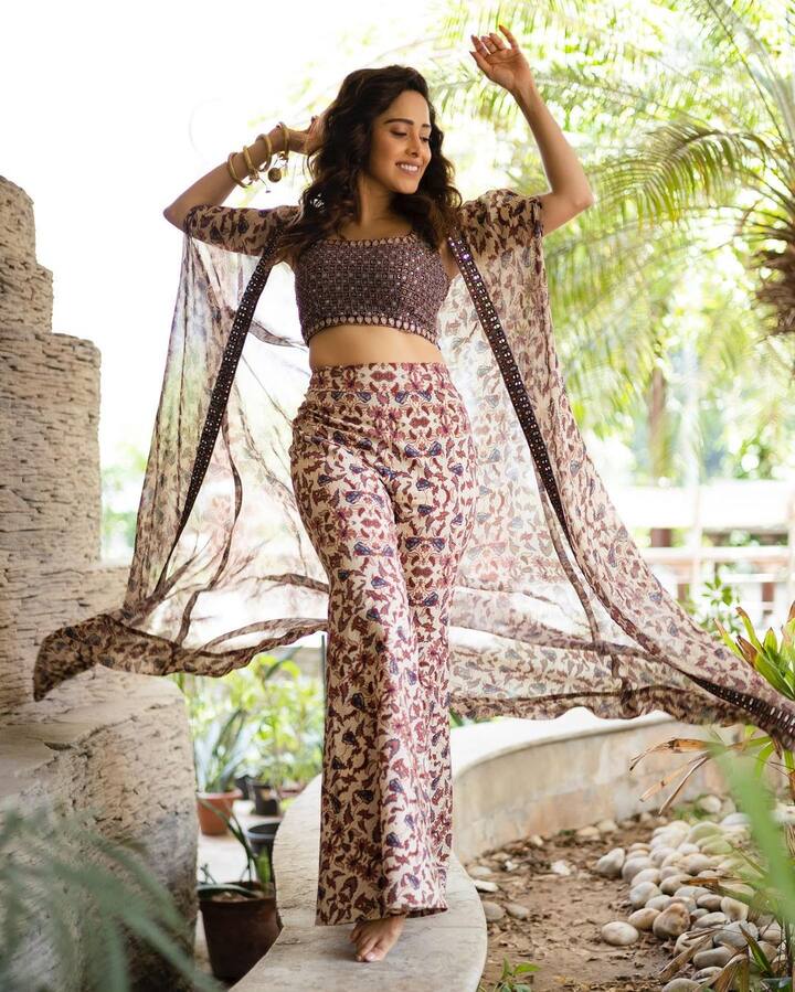 We can't stop staring at Nushrratt's co-ord outfit. She wore a crop blouse with a printed palazzo. Nushrratt paired her outfit with an intricately patterned shrug.