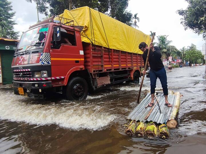 A man uses a makeshift boat to travel on a flooded road in Kamrup district. In Silchar, most localities are still water-logged and the situation remains critical, with residents facing a shortage of food, drinking water and medicines. (Source: PTI)