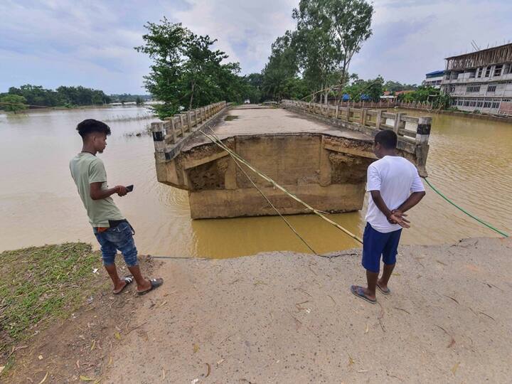 A damaged section of a bridge following floods in Nagaon district. Floodwaters have damaged 155 roads and five bridges while seven embankments have been breached. A total of 64 houses have been fully damaged and 5,693 partially damaged by the floods. (Source: PTI)