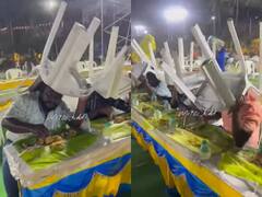 Watch: तेज बारिश में कुर्सी को बनाया शील्ड और एक हाथ से खाया खाना, वीडियो देख छूट जाएगी आपकी हंसी