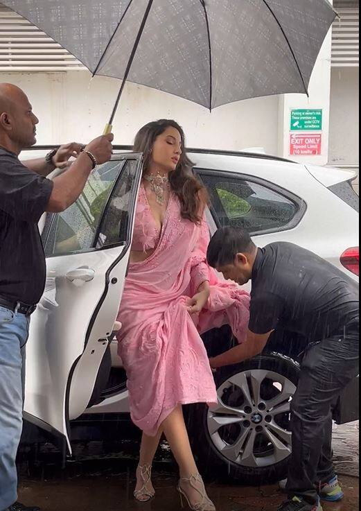 नोरा फतेही के लिए बारिश की वजह से साड़ी को संभालना हुआ मुश्किल, साड़ी संभालने के लिए पड़ रही है लोगों की जरूरत.