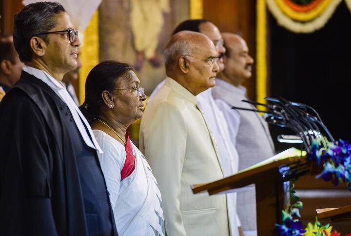 President Droupadi Murmu with outgoing President Ram Nath Kovind, Vice President M Venkaiah Nadu, Speaker Om Birla and CJI Justice N V Ramana (L) during her oath ceremony. Born on June 30, 1958 in Uparbeda village coming under Mayurbhanj district in Odisha, Murmu belongs to a Santali tribal family. Image Source PTI