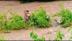 Odisha Monsoon Updates: Woman and her child stuck amid swollen river for hours | ABP News