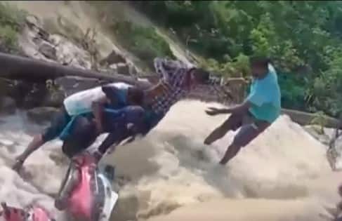 Telangana Monsoon Updates: Female teacher riding a scooter got trapped in water, locals rescue