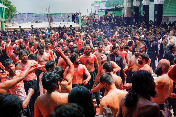 Amid cries of 'Ya Hussain' and recitation of 'marsiya' (elegies) and 'noha-khwani' (poems expressing sorrow), barefoot youths using knives, blade-encrusted chains and other sharp-edged weapons, inflicted injuries on themselves to show solidarity with the sufferings of the martyrs. (Image: PTI)