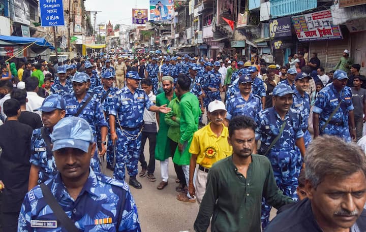 Security personnel patrol during a religious procession on the tenth day of the mourning period of Muharram, in Prayagraj. Security was also beefed up in Lucknow on Tuesday for Ashura, the 10th day of Muharram, with over 3,500 police personnel, mobile patrolling squads, Provincial Armed Constabulary (PAC) and Rapid Action Force (RAF) teams posted in sensitive areas of the city. (Image: PTI)