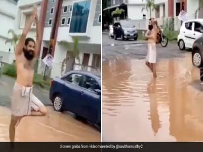 Man Takes Bath In Pothole To Protest Against Poor Roads In Kerala நடு ரோட்டில் சேற்று நீரில் குளியல்... யோகா செய்து நூதன போராட்டம்... இளைஞரின் வைரல் வீடியோ