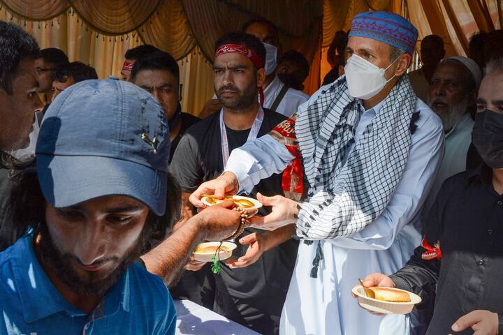 J&K National Conference Vice President Omar Abdullah distributes food among Shia Muslims during a religious procession on the tenth day of the mourning period of Muharram, in Srinagar. (Image: PTI)