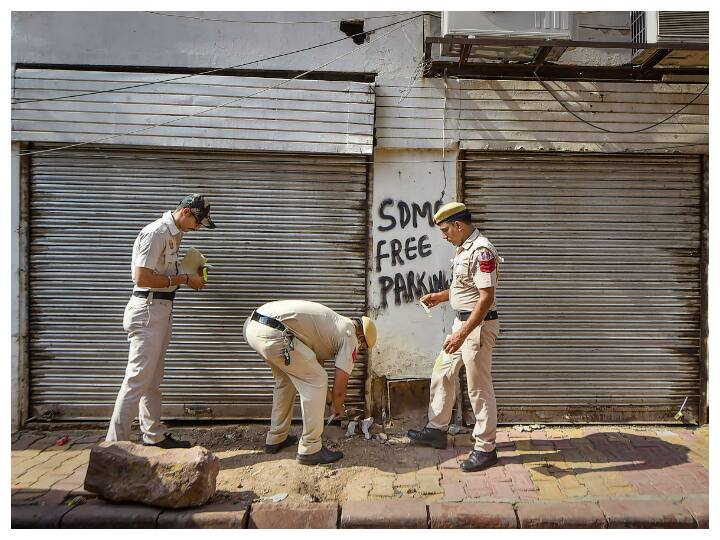 Police personnel seal shops near the Red Fort, as part of security arrangements for the 75th Independence Day ceremony, in New Delhi. (Image: PTI)