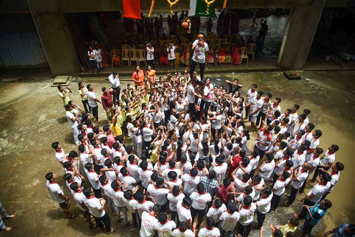 Students form a human pyramid to break the 'dahi handi' during 'Janmashtami' festival celebrations, at New Bombay City School in Navi Mumbai. (Image: PTI)