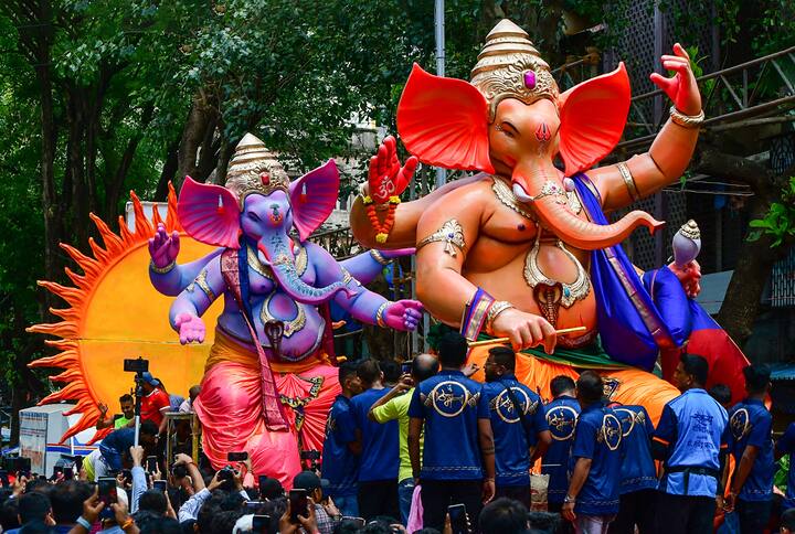 Devotees transport larger-than-life size idols of Lord Ganesha from a workshop to a 'pandal' ahead of the Ganesh Utsav, in Mumbai. (Image: PTI)