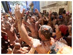 Spain: People Covered In Tomato Pulp Take Part In La Tomatina Festival After Two-Year Gap | IN PICS