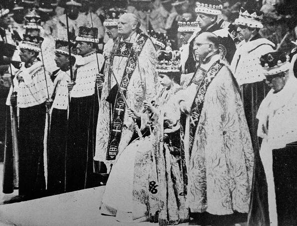 The scene after the crowning ceremony in Westminster Abbey, showing the Queen wearing the St. Edward Crown and holding the Sceptre and the Rod. (Image Source: Getty)