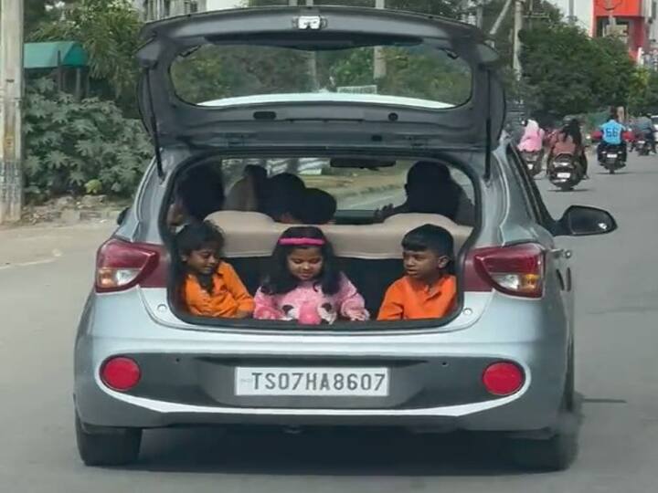 shocking video irresponsible parents 3 children sitting in open boot of a car video viral on social media Viral Video: लापरवाही की हद! खुद कार के अंदर बैठे, बच्चों को खुली डिक्की में बिठाया, वायरल हुआ वीडियो