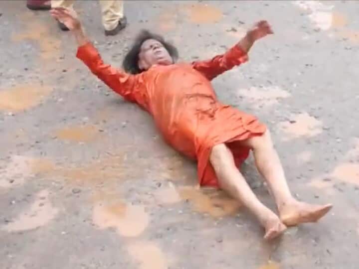 Watch: Social Worker Nityananda Protests Against Pothole-Riddled Road By Rolling On It In Udipi Watch: Social Worker Nityananda Protests Against Pothole-Riddled Road By Rolling On It In Udipi