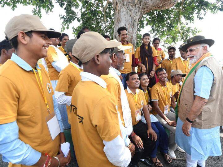 Prime Minister Narendra Modi speaks with wildlife caretakers after releasing cheetahs inside a special enclosure of the Kuno National Park in Madhya Pradesh, on Saturday. (Source: Twitter@narendramodi)