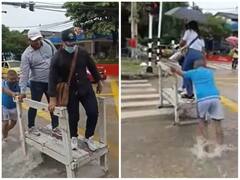 जुगाड़ू तकनीक से शख्स ने ढूंढा आपदा में अवसर, जलमग्न सड़क को पार कराने के लिए पैसे