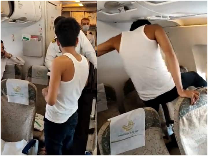 Passenger ruckus on Pakistani flight misbehaved with crew members and kicked the window video viral Viral Video: पाकिस्तानी फ्लाइट में पैसेंजर का हंगामा, क्रू मेंबर्स से की बदतमीजी और खिड़की पर मारी लात