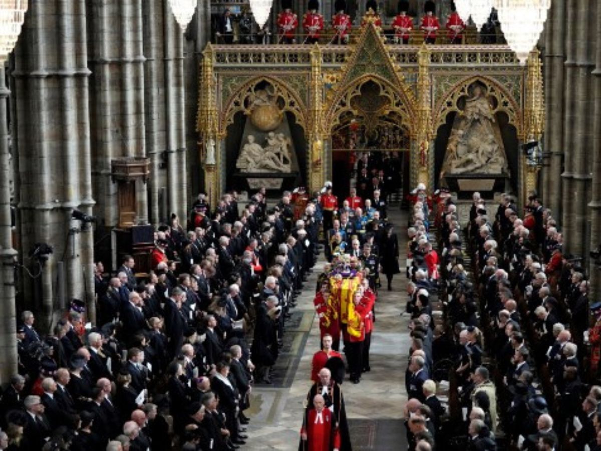 This image shows Queen Elizabeth II's coffin being carried out of Westminster Abbey