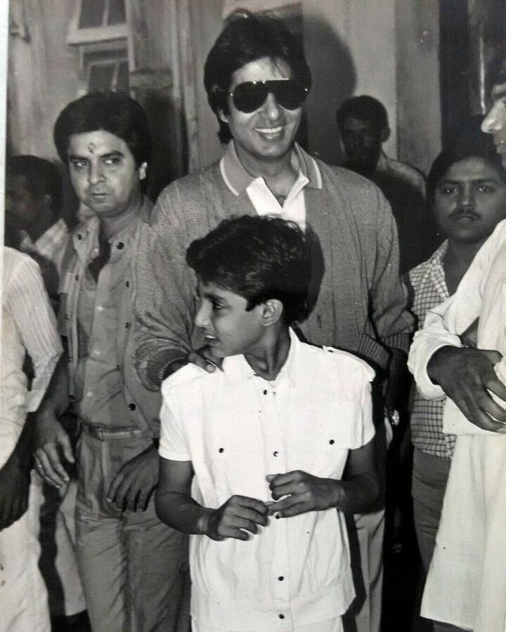 This picture shows a small Abhishek getting used to his father's stardom as the legend gets crowded by people.