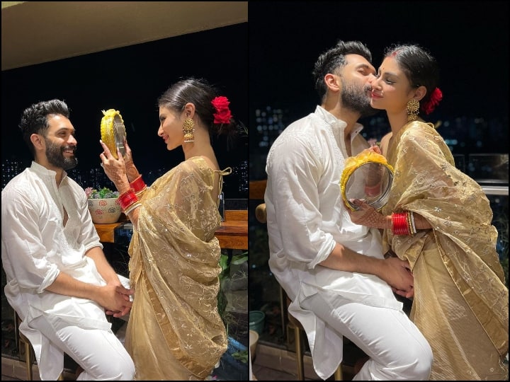 Mouni Roy Karva Chauth Photos: सूरज नाम्बियार से शादी के बाद एक्ट्रेस मौनी रॉय का ये पहला करवा चौथ है. छत पर व्रत तोड़ने के बाद कपल बेहद रोमांटिक होता नजर आया.