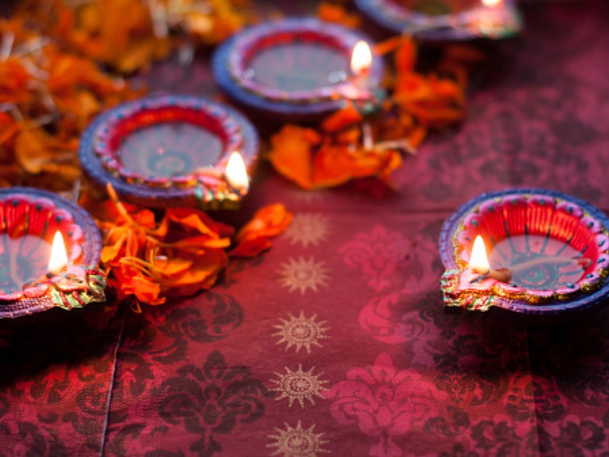 Lighting of diyas (oil lamps) during Diwali. (Image Source: Getty)