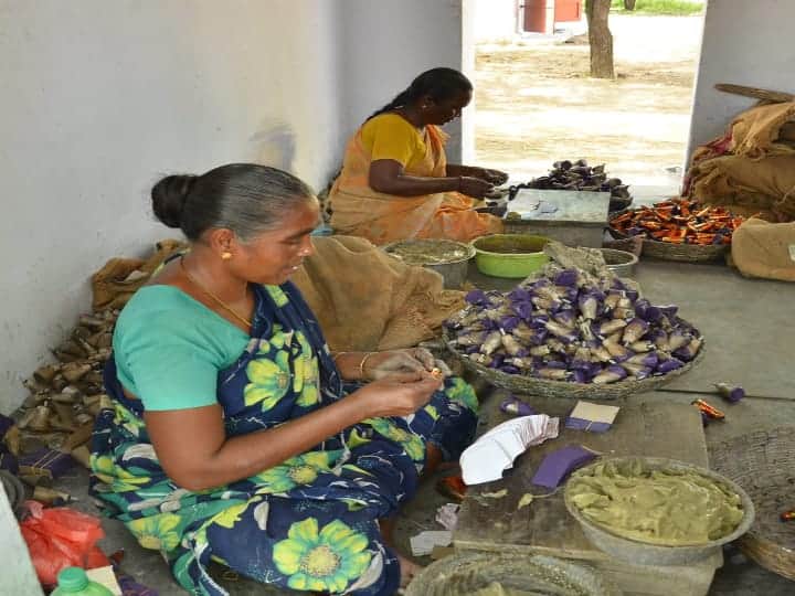 வெடிகளின் மீது ஸ்டிக்கர் ஒட்டும் பெண்கள்.