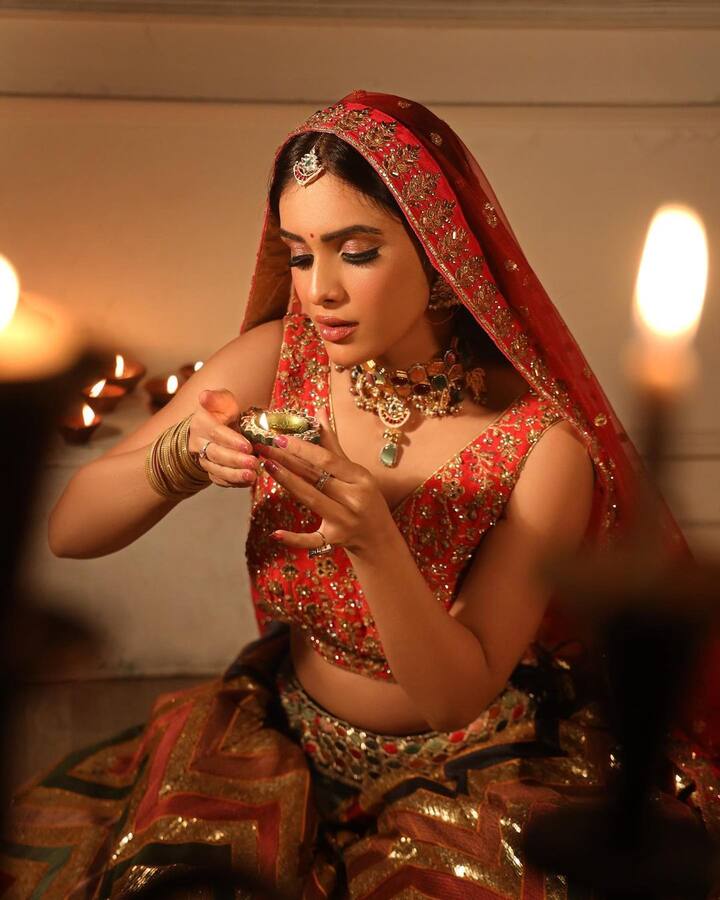 एक्ट्रेस ने लहंगे के साथ सिर पर दुपट्टा रखा हुआ है और न्यूड मेकअप किया हुआ. साथ ही उन्होंने हाथ में दीया भी लिया हुआ है.