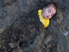 Children Buried Neck-Deep During Solar Eclipse 2022 In Pakistan. In Pics