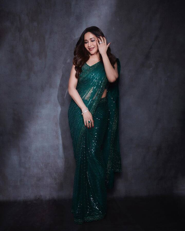 यासोबत तिने मॅचिंग ब्लाऊज पेअर केला आहे. हा लुक पूर्ण करण्यासाठी तिने हलका मेकअप केला आहे आणि केस मोकया लूकमध्ये ती खूपच सुंदर आणि ग्लॅमरस दिसत आहे. तिच्या या लूकवरून चाहत्यांना नजर हटवता येत नाही.(फोटो सौजन्य :madhuridixitnene/इंस्टग्राम )