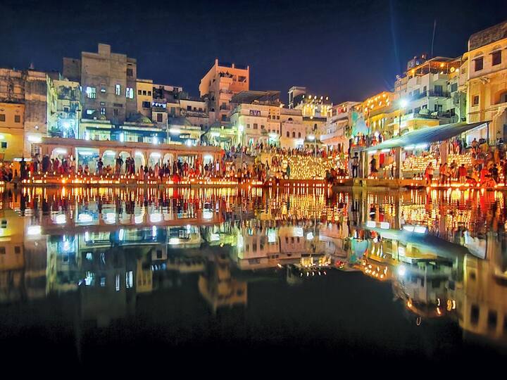 Rajasthan, known for its palaces, forts, culture and food, is witnessing a huge footfall during its annual eight-day Pushkar Fair, that started on November 1. The image shows people performing 'Deepdan' in Pushkar lake during the fair. (Source: PTI)