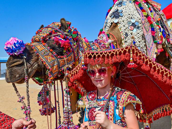A young woman with a decorated camel enjoys the photo session during the annual fair. This fair has several attractions and fun activities to attract the youngsters as well. (Source: PTI)