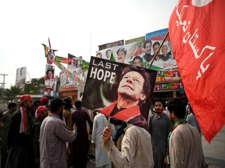 Supporters of former Pakistani Prime Minister Imran Khan demonstrate alongside a container truck at the cordoned-off scene of a gun assault in Wazirabad, a day after Khan's assassination attempt. (Image Source: AFP)