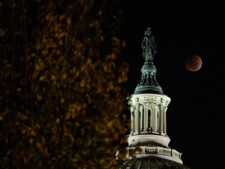 Beaver Blood Moon Lunar Eclipse 2022: Total lunar eclipse seen behind the Statue of Freedom atop the dome of the US Capitol Building in Washington, DC, on Election Day, on November 8, 2022. This was the last total lunar eclipse for three years. (Photo: Getty)