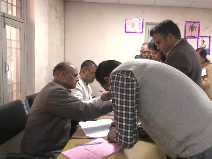People cast their votes for the Assembly election at polling booth number 12 in Dharamshala.