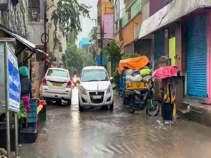 In the midst of constant rain, commuters wade through a flooded roadway. According to an IMD advisory, a well marked low pressure area 