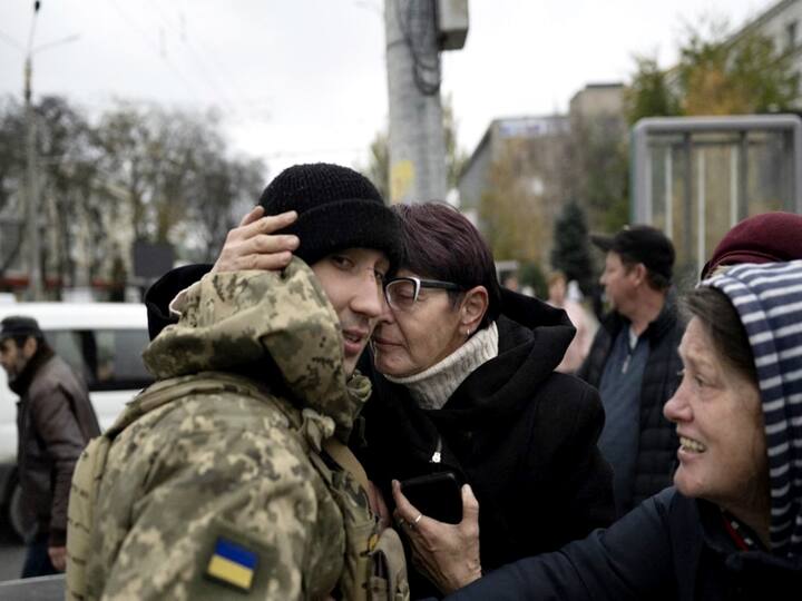 A woman hugs a Ukrainian soldier as local residents gather to celebrate the liberation of Kherson. (Photo: AFP)