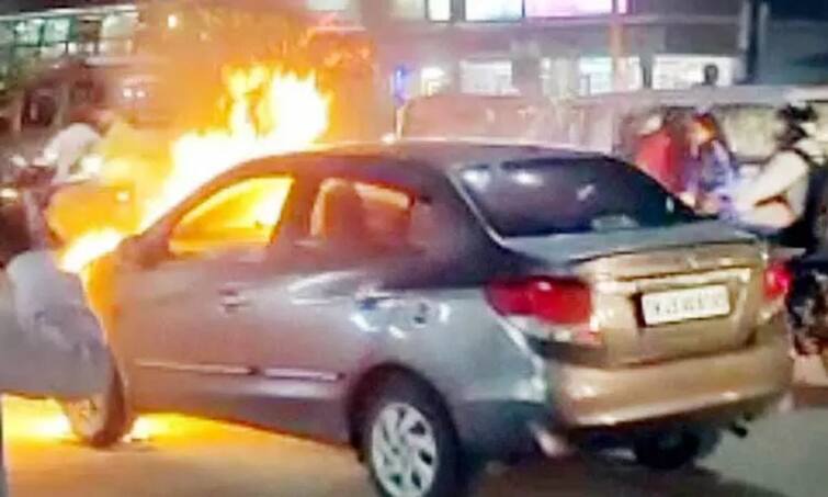 Trichy: car traveling on the Trichy-Tanjai highway suddenly caught fire causing a commotion TNN திருச்சி அருகே ஓடும் கார் தீப்பற்றி எரிந்ததால் பரபரப்பு - உயிர் தப்பிய குடும்பம்