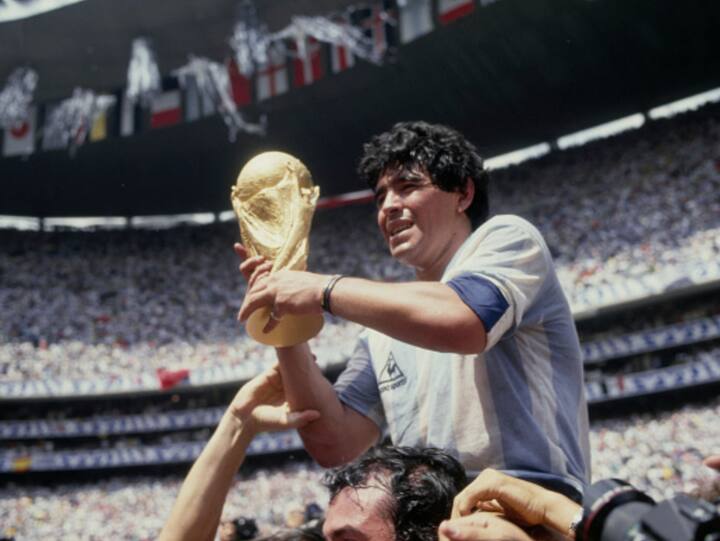 Argentine professional football player Diego Armando Maradona (1960 - 2020) holds the World Cup trophy after Argentina defeated West Germany 3-2 during the 1986 FIFA World Cup Final match at the Azteca Stadium in Mexico City, Mexico, 29th June 1986. (Image Source: Getty Images)