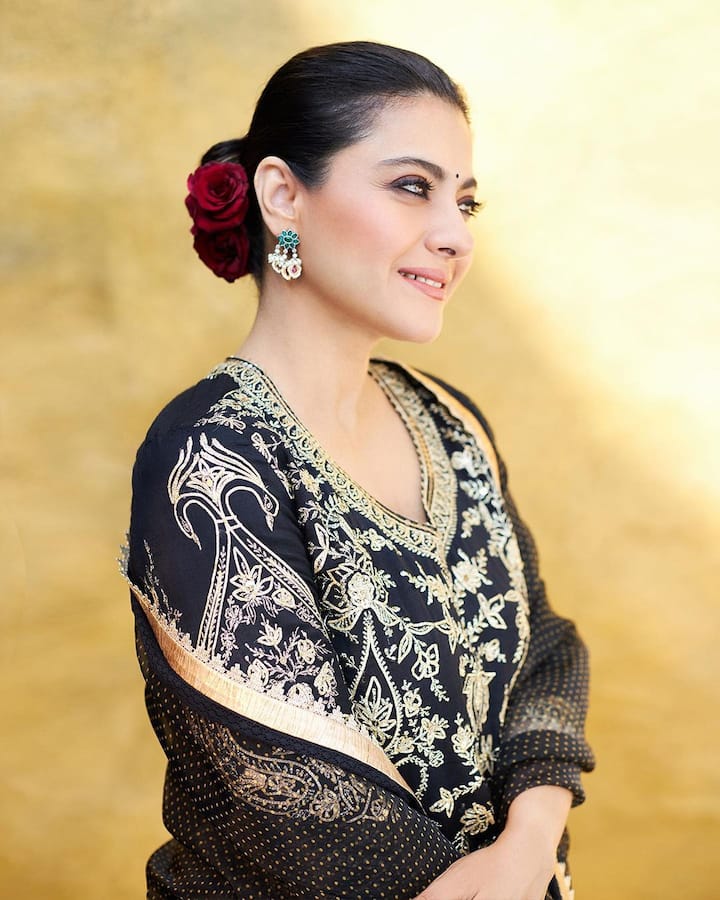 Tying up her hair in a bun, she adorned it with red roses. A black bindi completed her look. (All image: Kajol/Instagram).