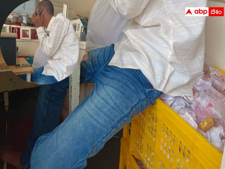 Sanitation worker Sudhakar sitting on laddoos at Bejawada Durgamma temple dnn దుర్గగుడిలో మరో వివాదం- ప్రసాదంపై కుర్చొని, ఫోన్ మాట్లాడిన ఉద్యోగి